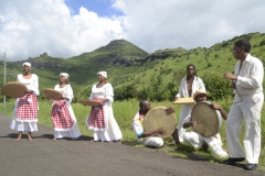 A formal choreographed performance; female dancers with traditional costumes move while enacting the words in the song and moving to the beat of the ravann, maravann and triyang
