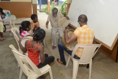 Alain Muneean (Abaim Group) teaching the beginners how to play the ravann, at Ravann School Cite Barkly Beau Bassin